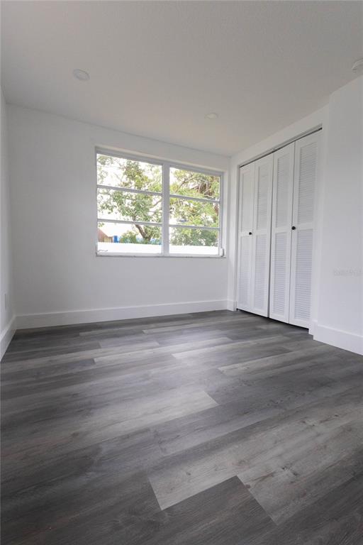 6340 Westport Drive Port Richey, FL 34668 - Photo 30 of 51 a view of an empty room with wooden floor and a window