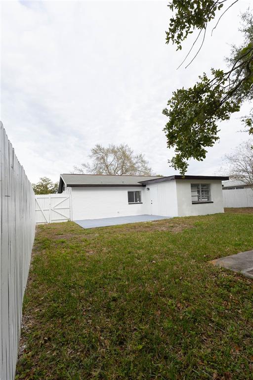 6340 Westport Drive Port Richey, FL 34668 - Photo 41 of 51 a view of a backyard with plants and lake view