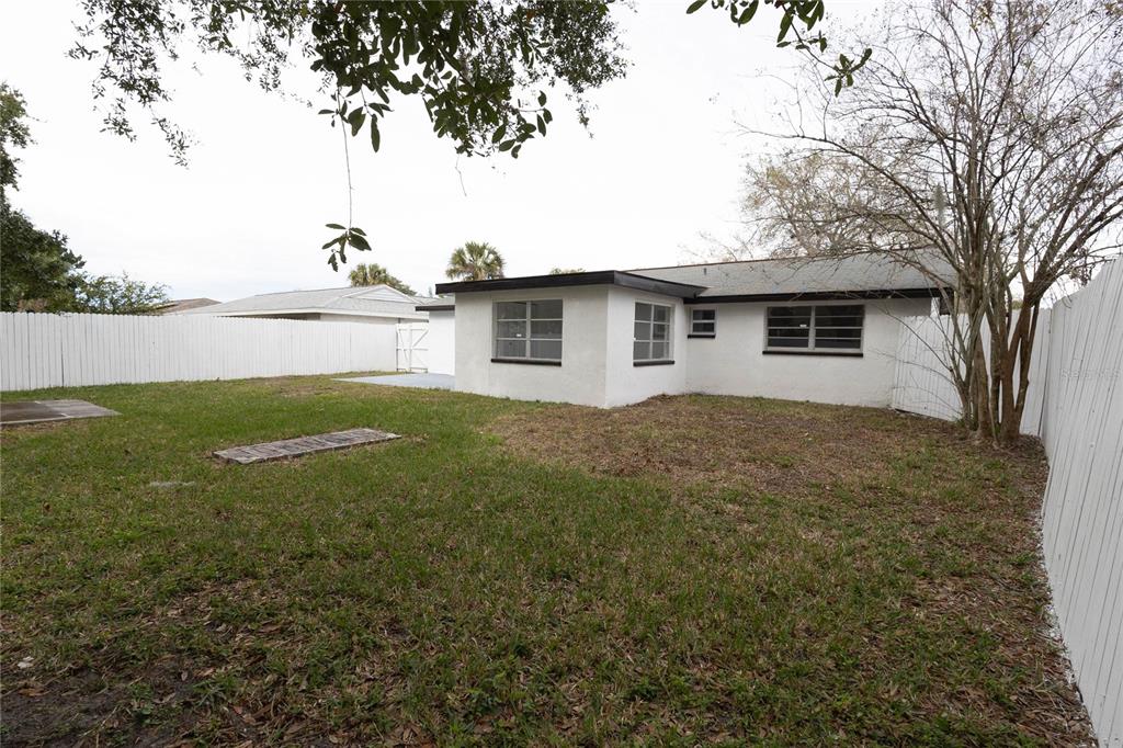 6340 Westport Drive Port Richey, FL 34668 - Photo 44 of 51 a view of a house with a yard