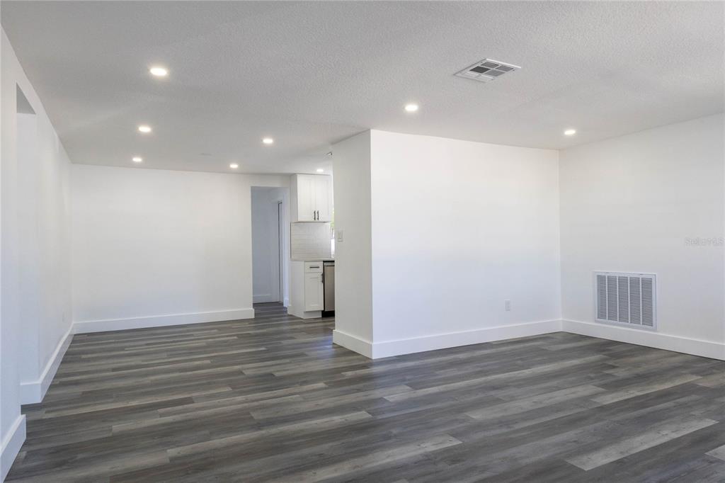 6340 Westport Drive Port Richey, FL 34668 - Photo 10 of 51 a view of an empty room with wooden floor