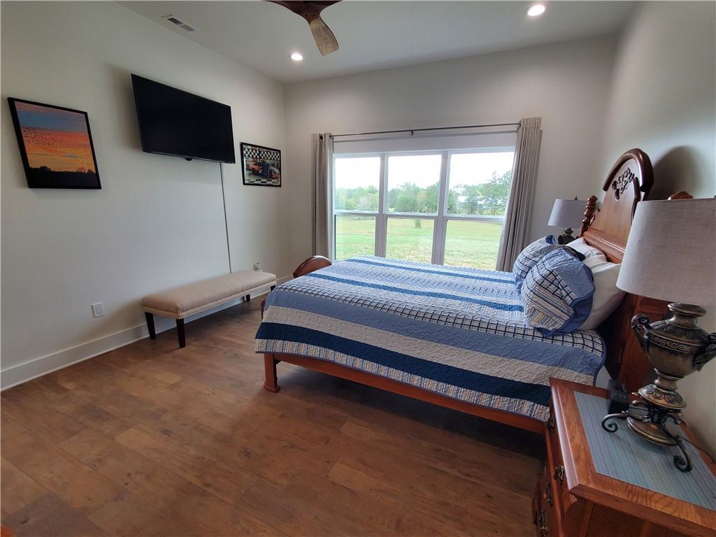 876 Cline Road Resaca, GA 30735 - Photo 22 of 78 a bedroom with a bed a flat screen tv and a large window