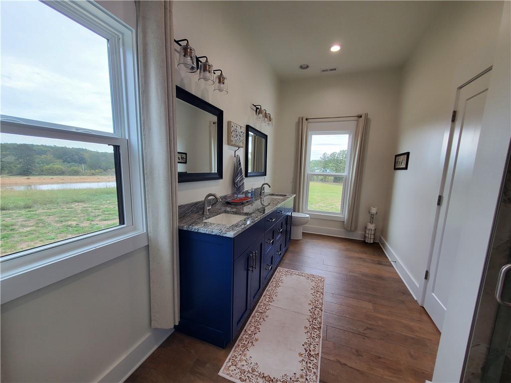 876 Cline Road Resaca, GA 30735 - Photo 24 of 78 a bathroom with a granite countertop sink and a large mirror