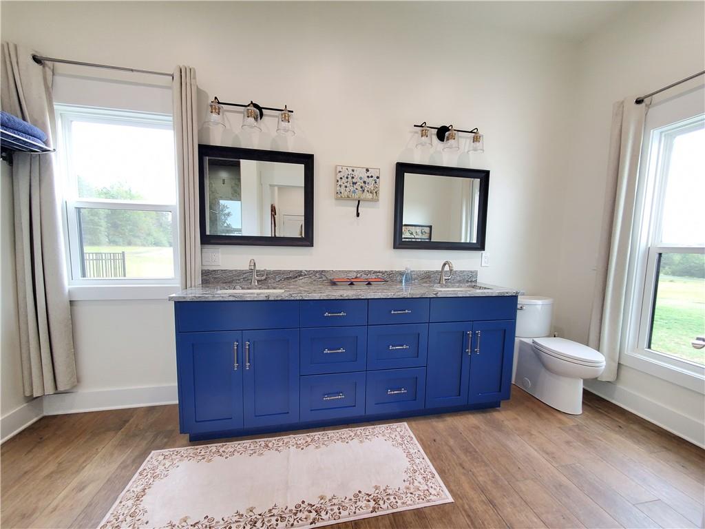 876 Cline Road Resaca, GA 30735 - Photo 25 of 78 a bathroom with a granite countertop double vanity sink a mirror and a window