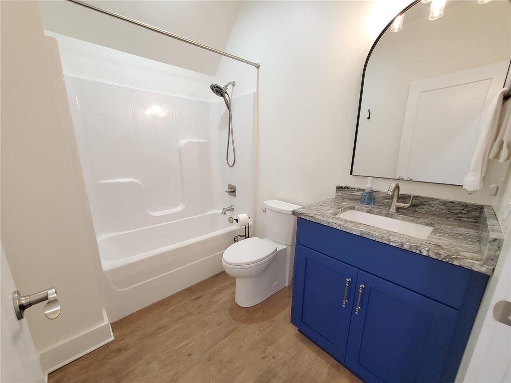 876 Cline Road Resaca, GA 30735 - Photo 38 of 78 a bathroom with a granite countertop sink toilet mirror and shower