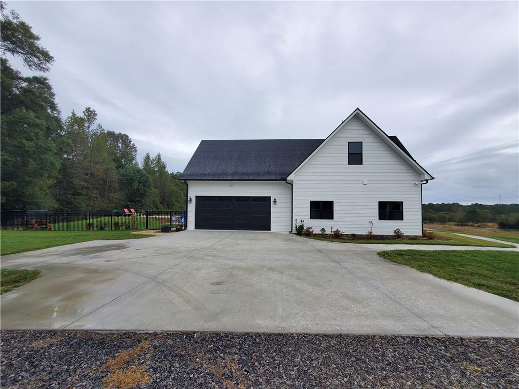876 Cline Road Resaca, GA 30735 - Photo 56 of 78 a front view of a house with a yard and garage
