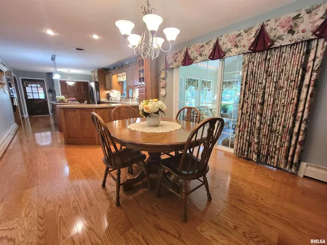 a view of a dining room with furniture and a chandelier