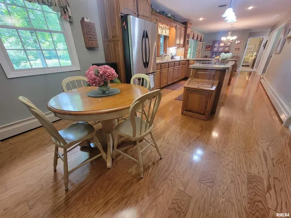 a view of a dining room with furniture wooden floor and chandelier
