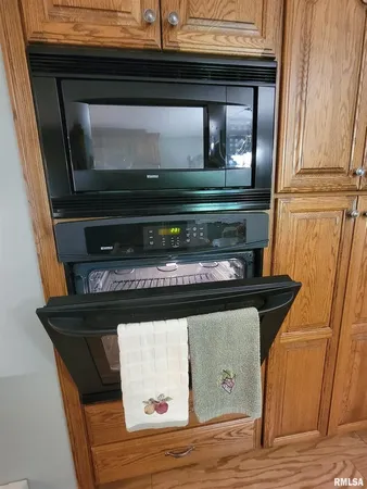 a bed sitting in a bedroom next to a window with dresser