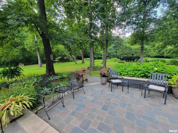 a view of a table and chairs in the garden