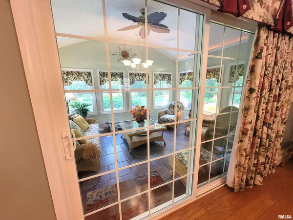 a bedroom with furniture and a large window