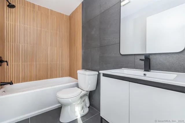 a bathroom with a toilet a sink and bathtub