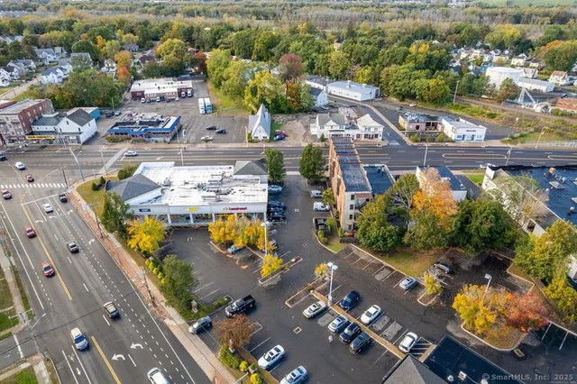 an aerial view of a swimming pool with outdoor seating