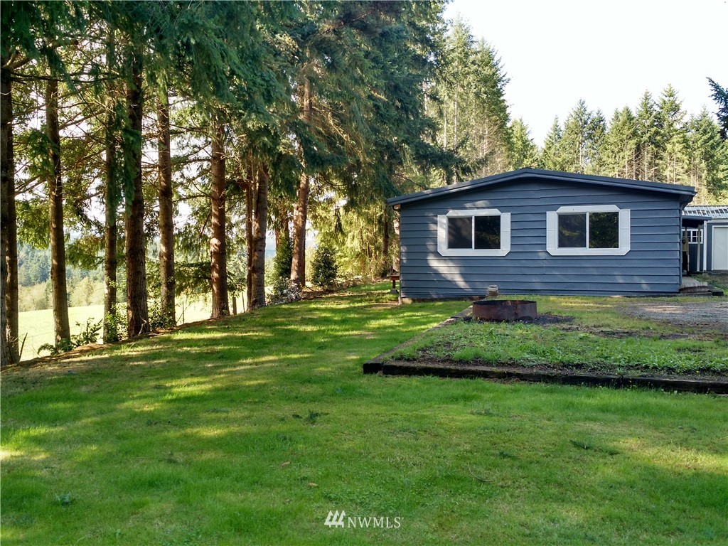 150 Nix Road Chehalis, WA 98532 - Photo 4 of 13 a brick house next to a yard with a large tree