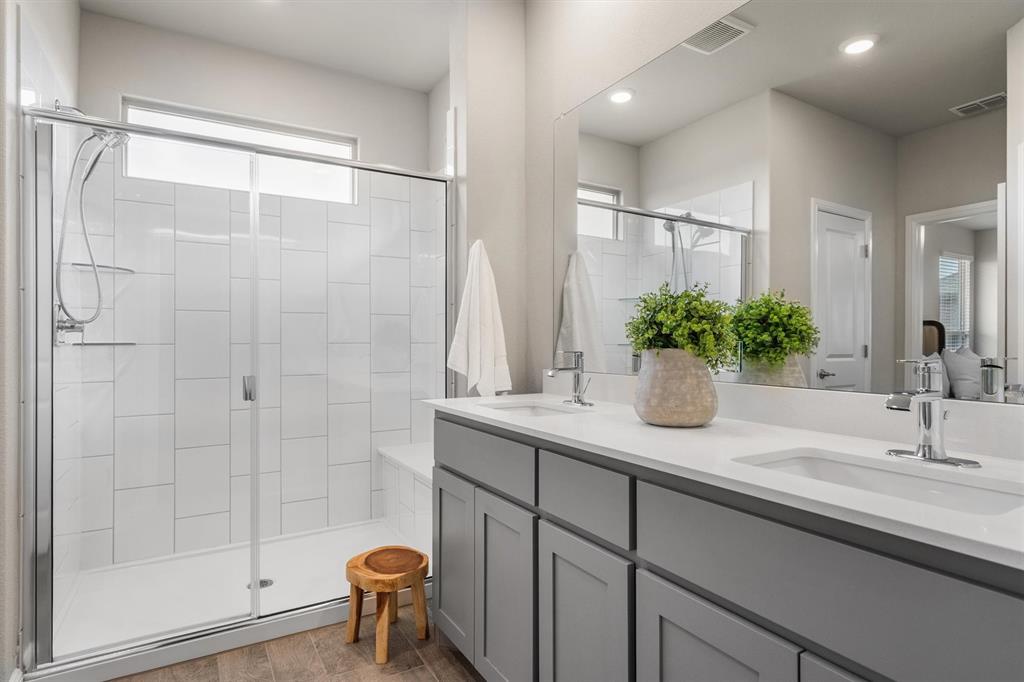 1864 Mensa Drive Haslet, TX 76052 - Photo 28 of 40 a bathroom with a sink a potted plant and a shower