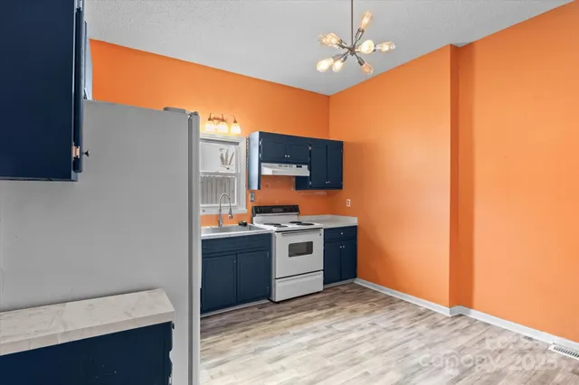 a kitchen with stainless steel appliances granite countertop a stove and a refrigerator