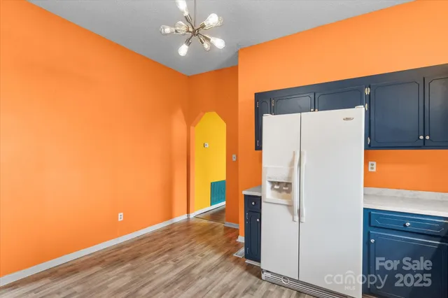 a white refrigerator freezer sitting inside of a kitchen