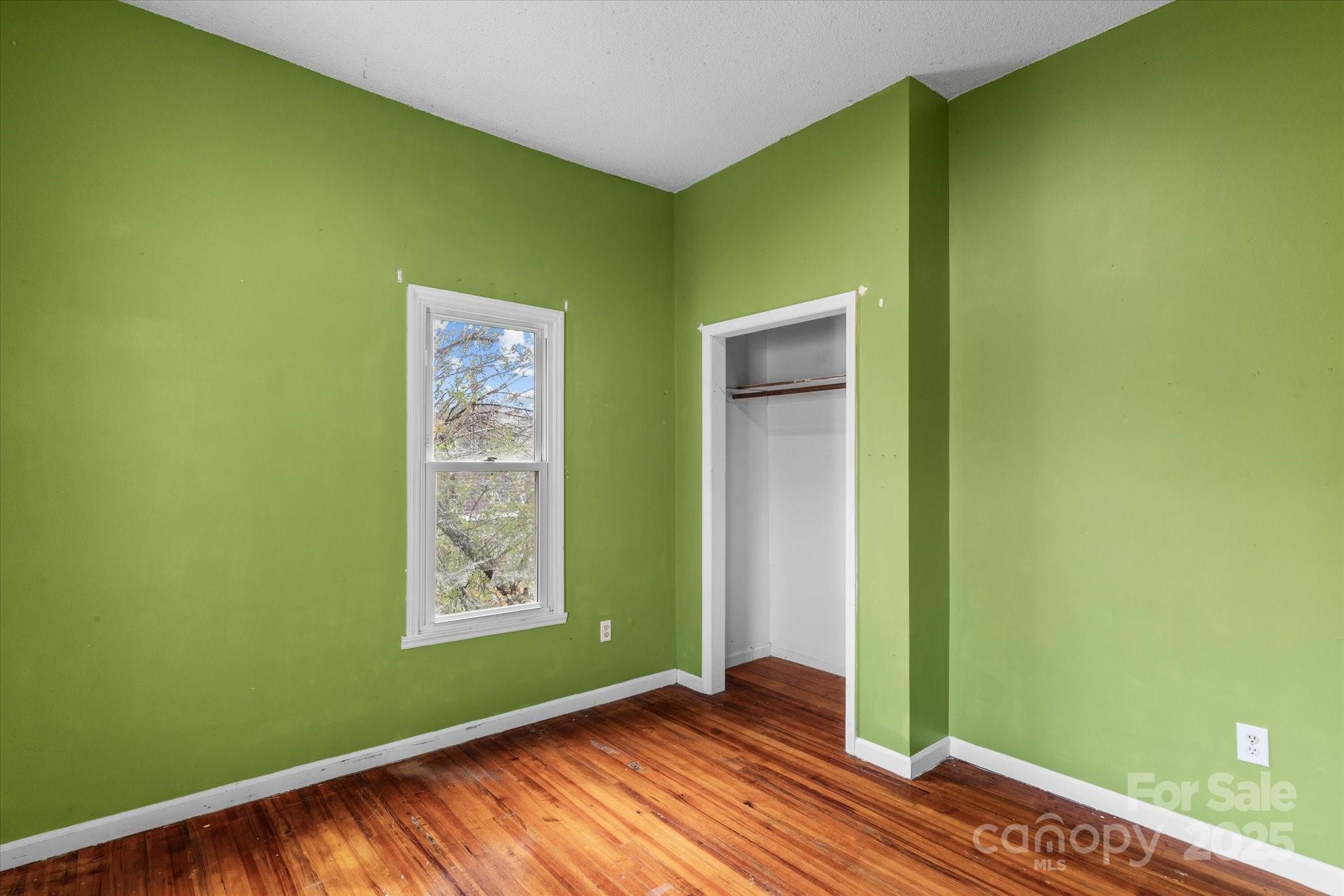 30 2nd Street Cramerton, NC 28032 - Photo 16 of 21 a view of an empty room with window and wooden floor
