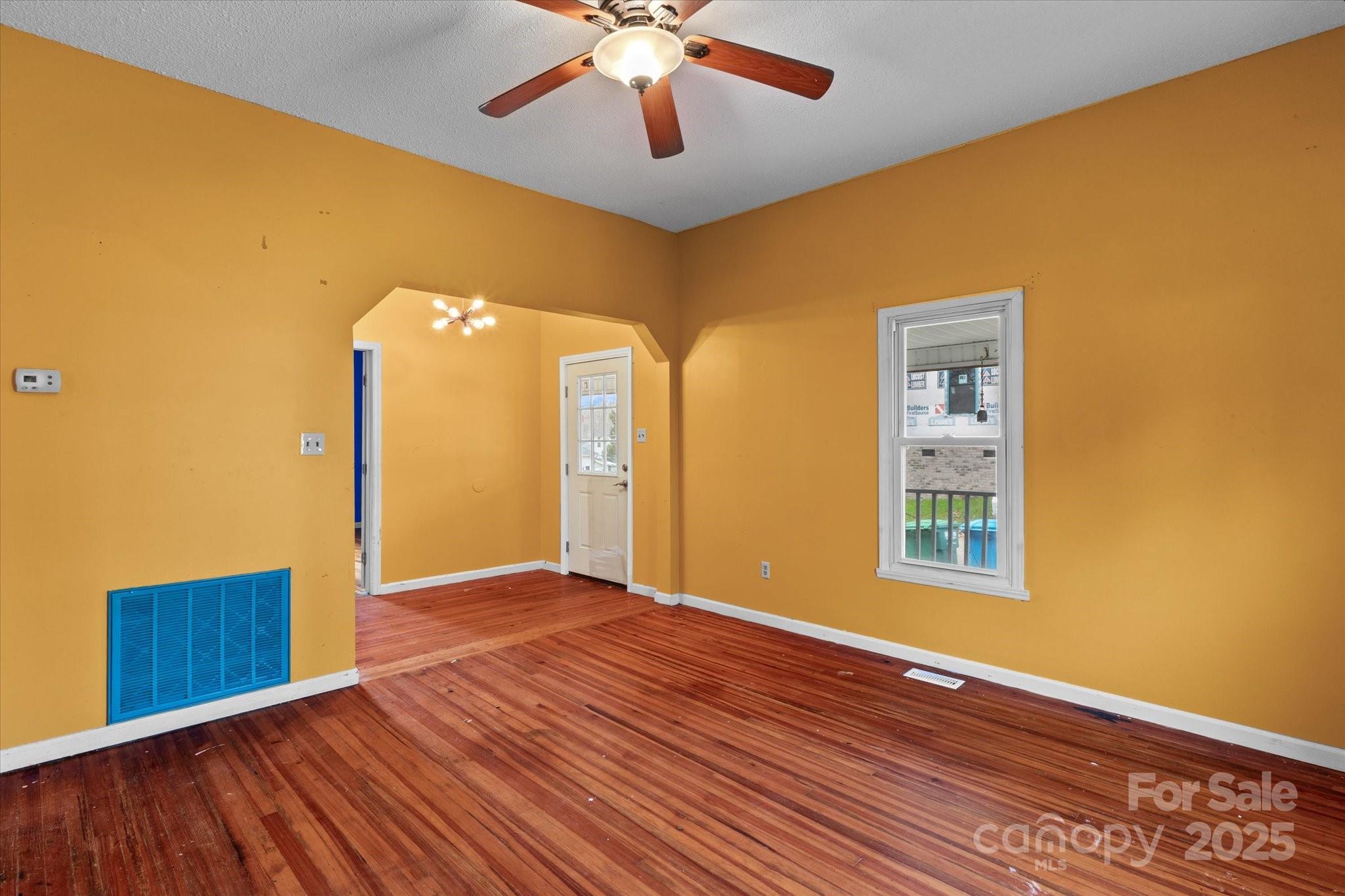 30 2nd Street Cramerton, NC 28032 - Photo 8 of 21 a view of an empty room with window and wooden floor