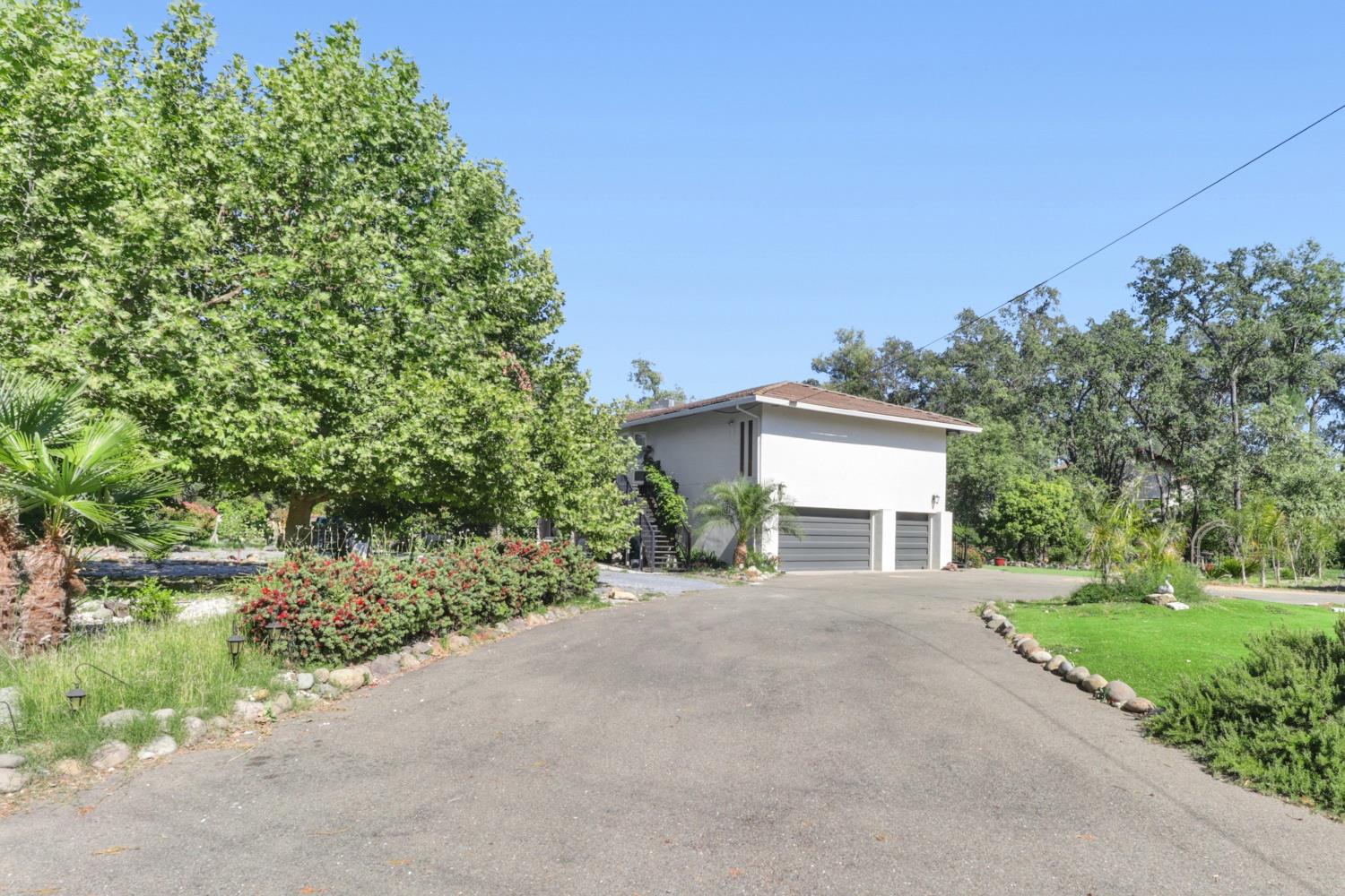 4330 Cavitt Stallman Road Granite Bay, CA 95746 - Photo 72 of 85 a front view of a house with a yard and garage