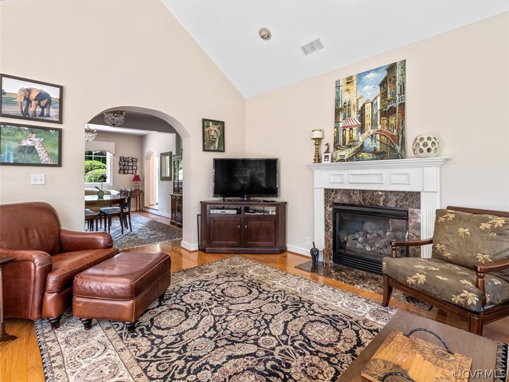 4610 Butte Road Richmond, VA 23235 - Photo 11 of 48 a living room with furniture a flat screen tv and a fireplace