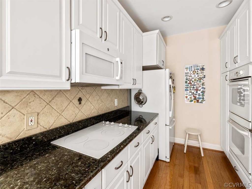 4610 Butte Road Richmond, VA 23235 - Photo 15 of 48 a kitchen with granite countertop a stove a sink a refrigerator and white cabinets with wooden floor