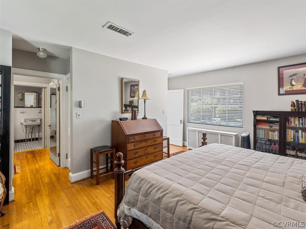 4610 Butte Road Richmond, VA 23235 - Photo 18 of 48 a bedroom with a bed and wooden floor
