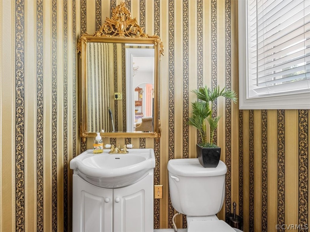 4610 Butte Road Richmond, VA 23235 - Photo 21 of 48 a bathroom with a sink a toilet and a mirror