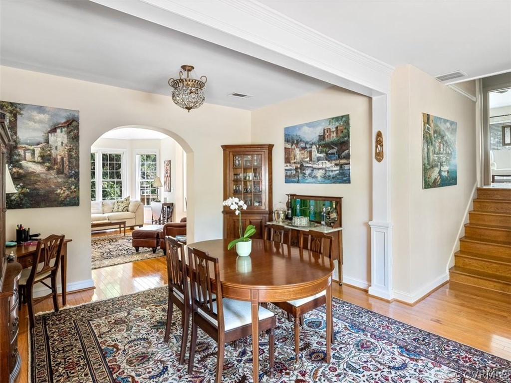 4610 Butte Road Richmond, VA 23235 - Photo 6 of 48 a dining room with wooden floor a chandelier a wooden table and chairs