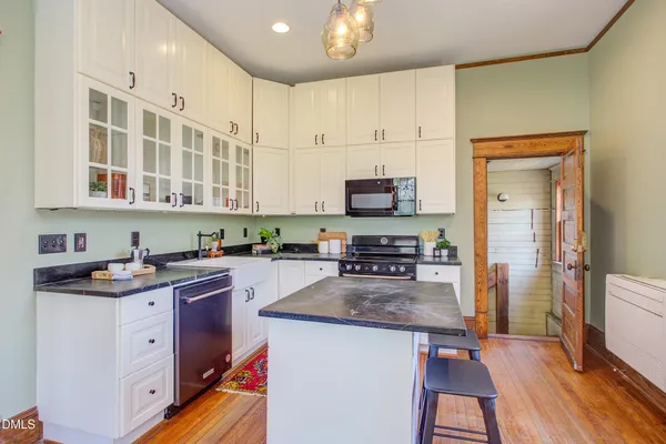 a kitchen with stainless steel appliances granite countertop a stove refrigerator sink and cabinets