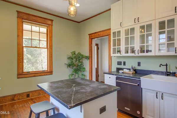 a kitchen that has a sink and a chair in it