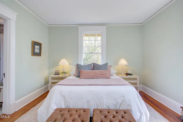 a bedroom with bed and a window