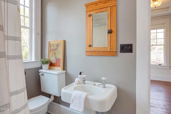 a bathroom with a sink toilet and mirror