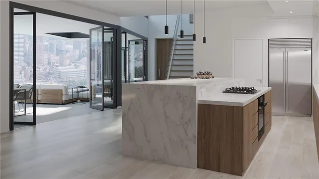 a kitchen with stainless steel appliances kitchen island granite countertop a refrigerator and a stove top oven