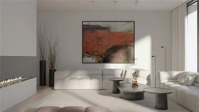 a living room with furniture and a painting