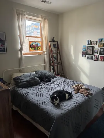 a bed sitting in a bedroom next to a window