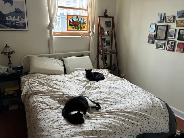 a bedroom with a bed and wall painting