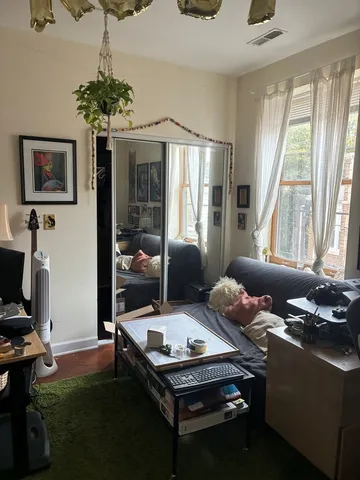 a living room with furniture and a floor to ceiling window