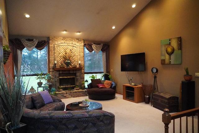 265 Grandin Road Morris, IL 60450 - Photo 2 of 29 a living room with furniture a flat screen tv and a fireplace