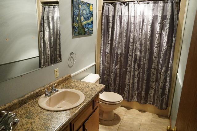 265 Grandin Road Morris, IL 60450 - Photo 16 of 29 a bathroom with a granite countertop sink toilet and mirror
