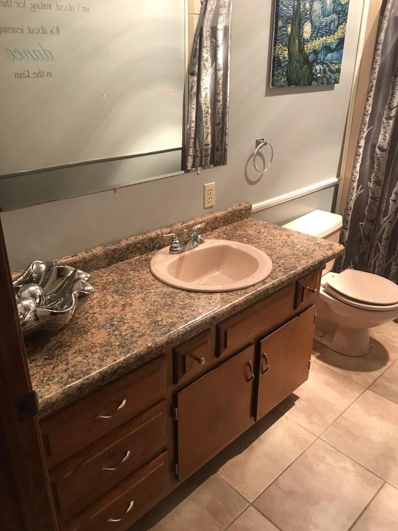 265 Grandin Road Morris, IL 60450 - Photo 17 of 29 a bathroom with a granite countertop sink and a mirror