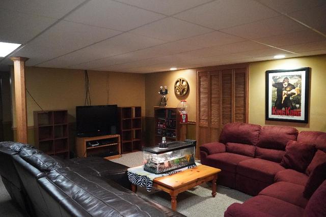 265 Grandin Road Morris, IL 60450 - Photo 18 of 29 a living room with furniture a air conditioner and a flat screen tv