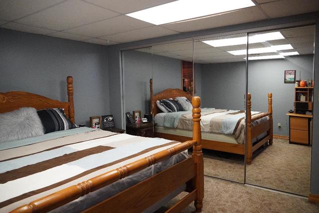 265 Grandin Road Morris, IL 60450 - Photo 20 of 29 a bedroom with bed and a chandelier