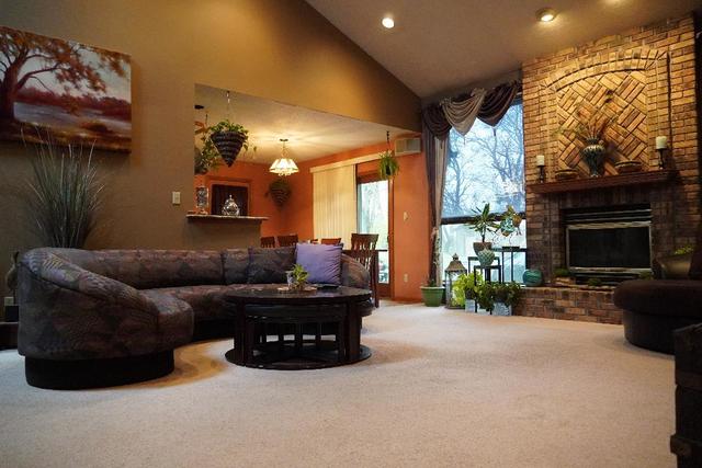 265 Grandin Road Morris, IL 60450 - Photo 3 of 29 a living room with furniture a fireplace and a flat screen tv