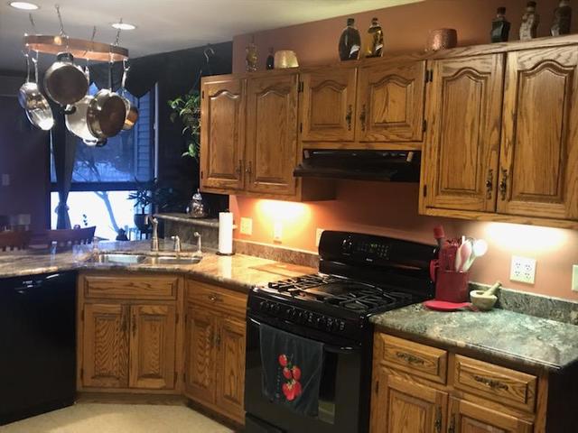 265 Grandin Road Morris, IL 60450 - Photo 5 of 29 a kitchen with granite countertop a stove top oven cabinetry a sink and dishwasher