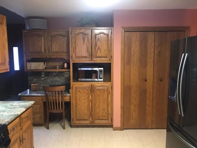 265 Grandin Road Morris, IL 60450 - Photo 7 of 29 a kitchen with granite countertop a refrigerator and a stove top oven
