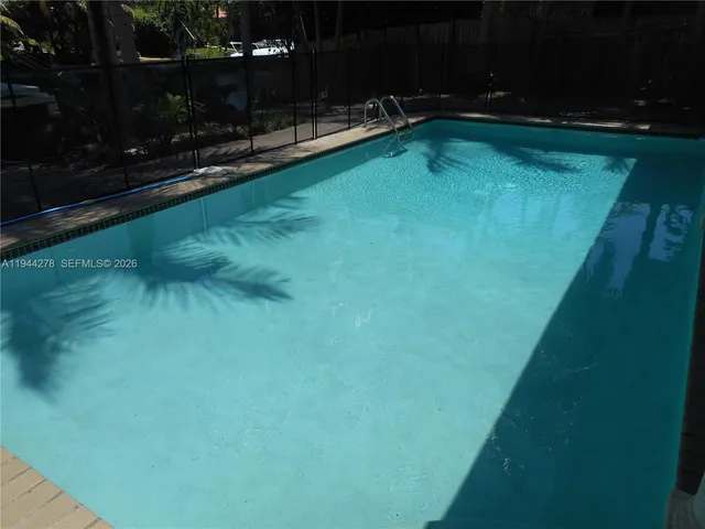 a view of a lake with chairs
