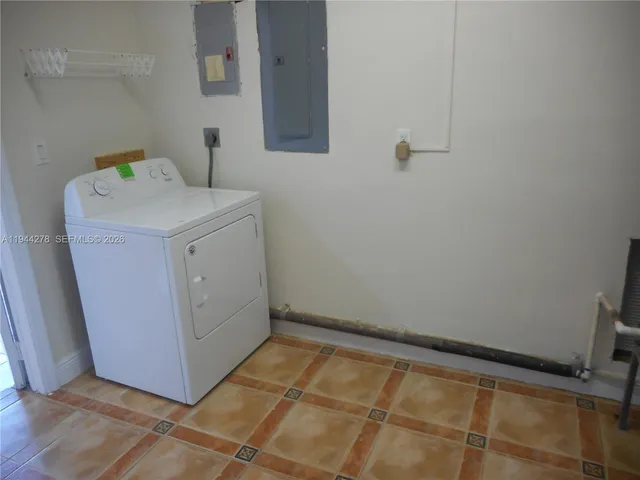 a backyard of a house with plants and trees