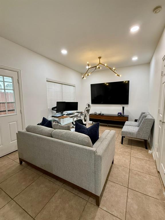 417 Moonlight Way Irving, TX 75063 - Photo 12 of 31 a living room with furniture and a flat screen tv