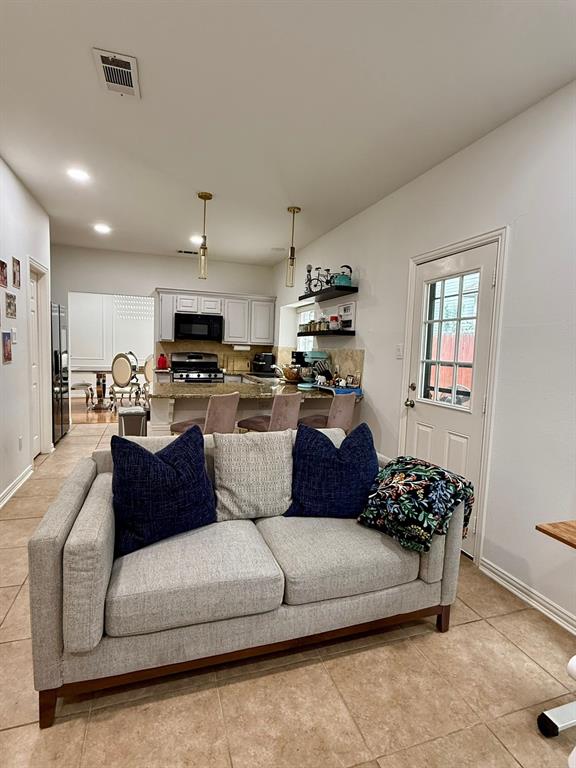 417 Moonlight Way Irving, TX 75063 - Photo 13 of 31 a living room with furniture and a flat screen tv