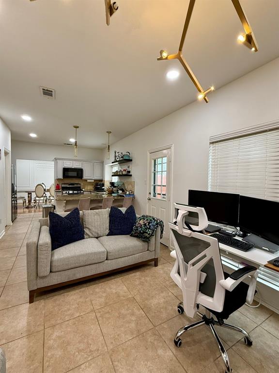 417 Moonlight Way Irving, TX 75063 - Photo 14 of 31 a living room with furniture and a flat screen tv